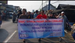 Puluhan warga, membentangkan spanduk silakan raya, menolak revitalisasi pasar Cimalaka. (Memanggil.co/Husni Nursyaf)
