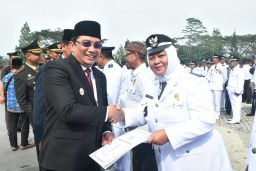 Pj. Bupati Sumedang Yudia Ramli saat menyerahkan SK perpanjangan Masa jabatan  kades di lapangan upacara pusat pemerintahan sumedang (ist) 